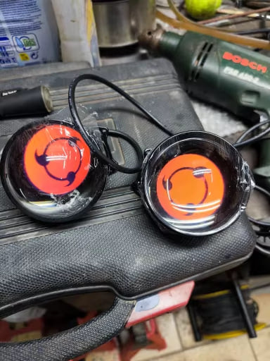 Both lenses on a workbench showing a custom orange graphic uploaded by the owner - customer photo